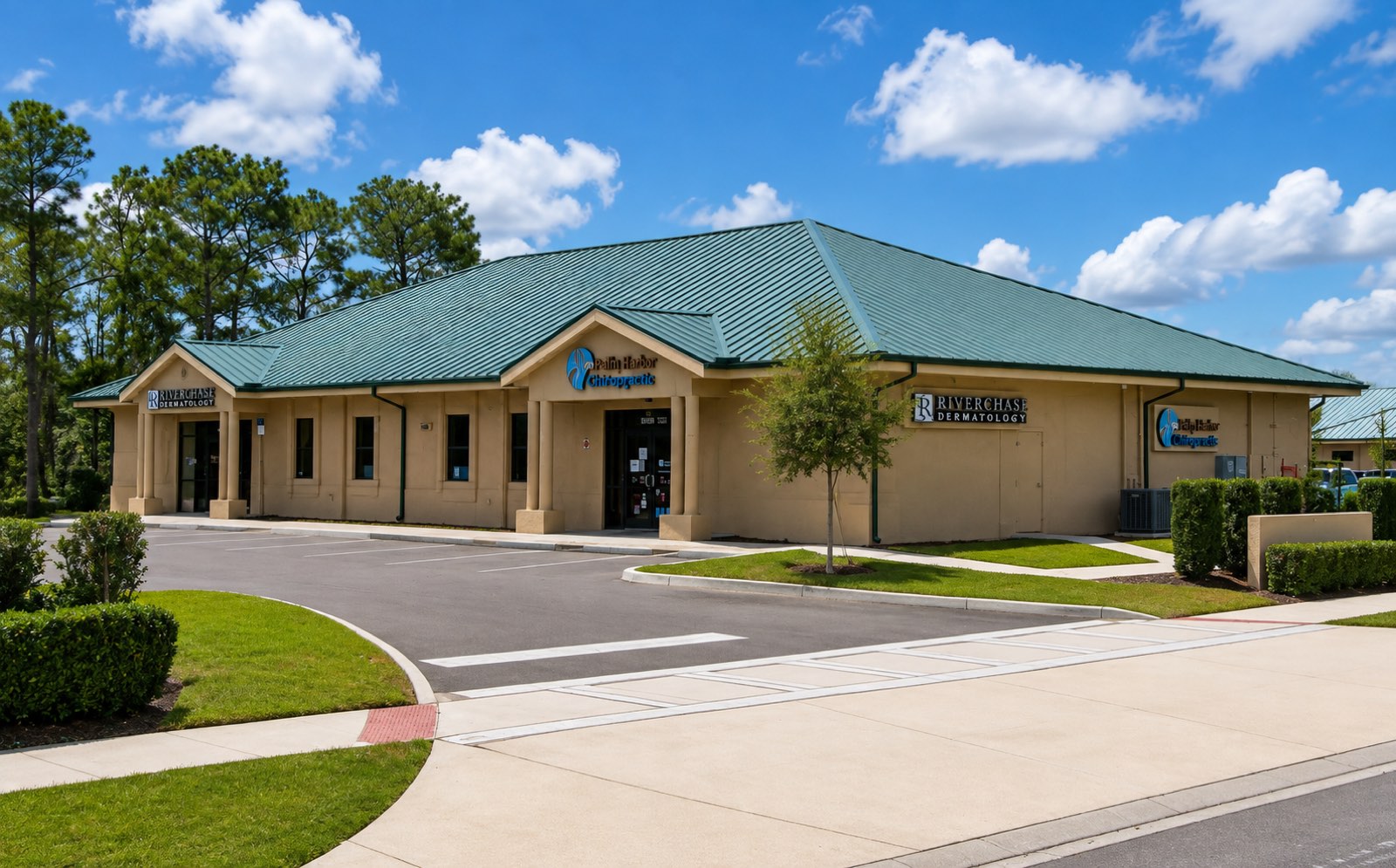Commonwealth 1007: a single-story office building with a green standing-seam metal roof and two columned porticos.