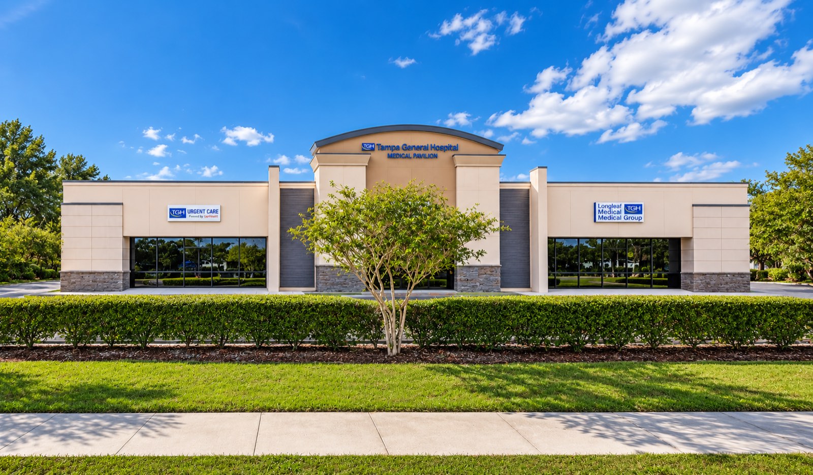 Sun Plaza Building 1 in Wimauma: a modern single-story medical building with a stone base, storefront glass and a curved parapet over the entrance.